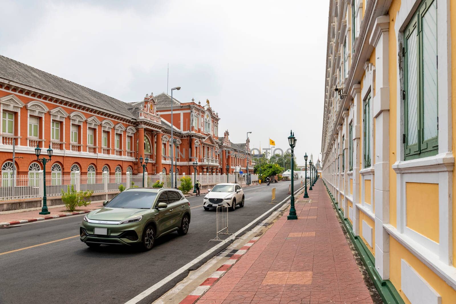 Bangkok,Thailand - April 16, 2023: The yellow building contrasts with the white stripes and has light green windows of Thailand's Ministry of Defense. A popular spot for tourists to take pictures.