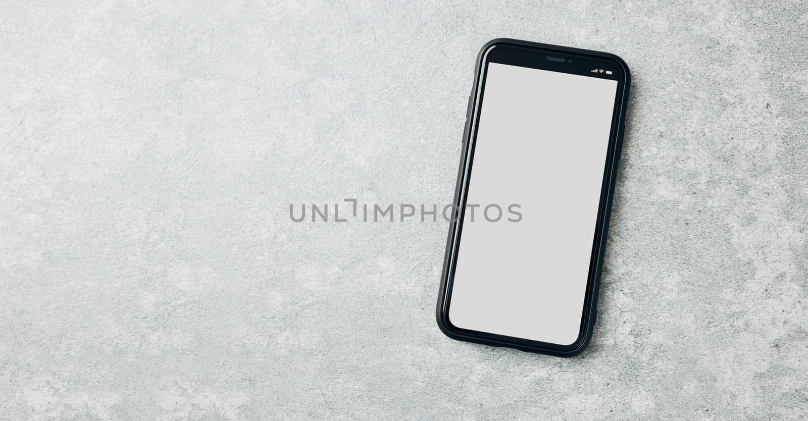 Smartphone mockup with solid white color blank empty isolated screen on marble background. Black mobile phone top view flat lay with copy space. Ready for content. Room for text