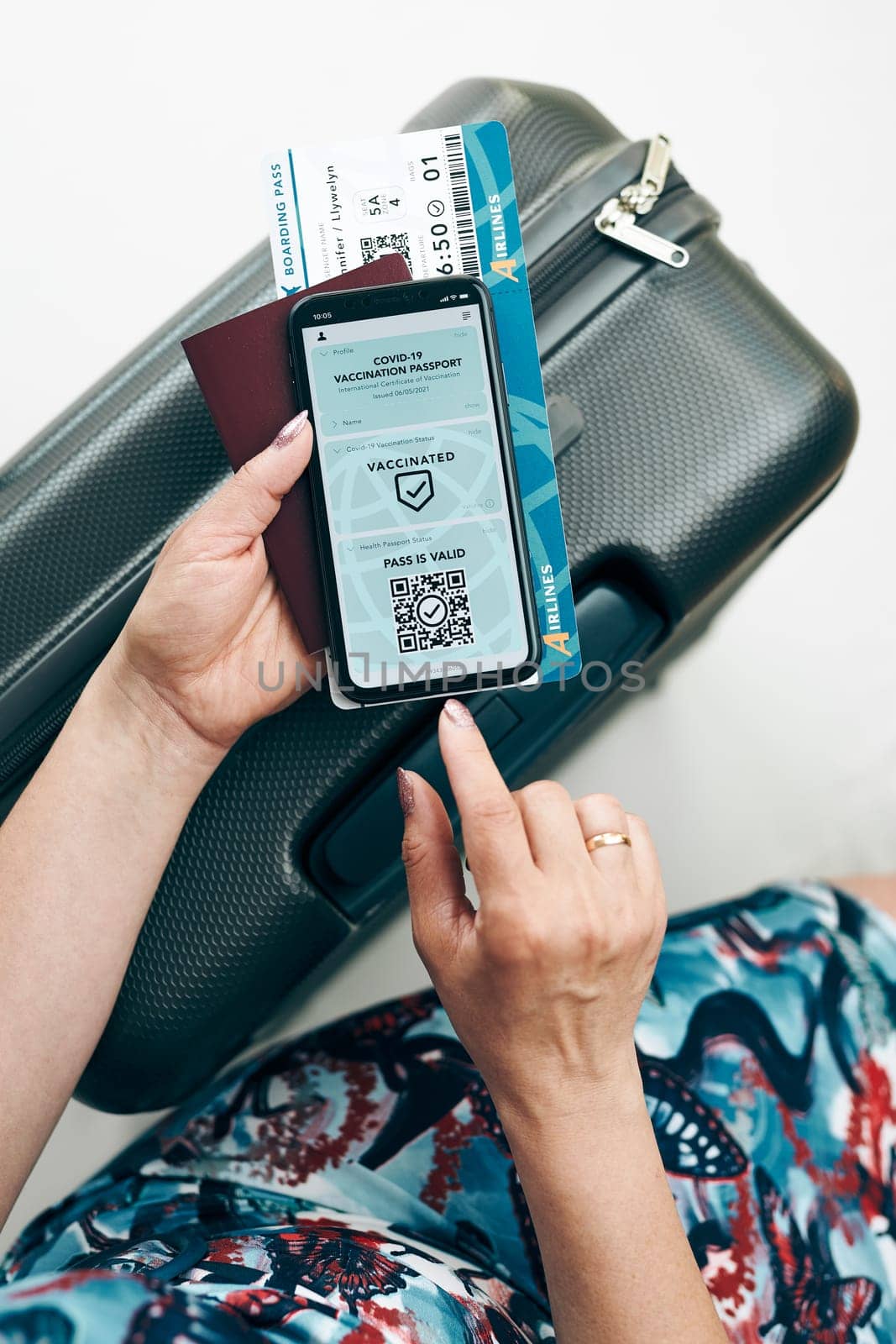 Digital covid certificate. Covid negative rapid digital test pass. Woman passenger holding digital medical pass on her mobile phone, passport and airplane ticket. Traveler showing digital covid test result as medical pass for travel during covid-19 pandemic