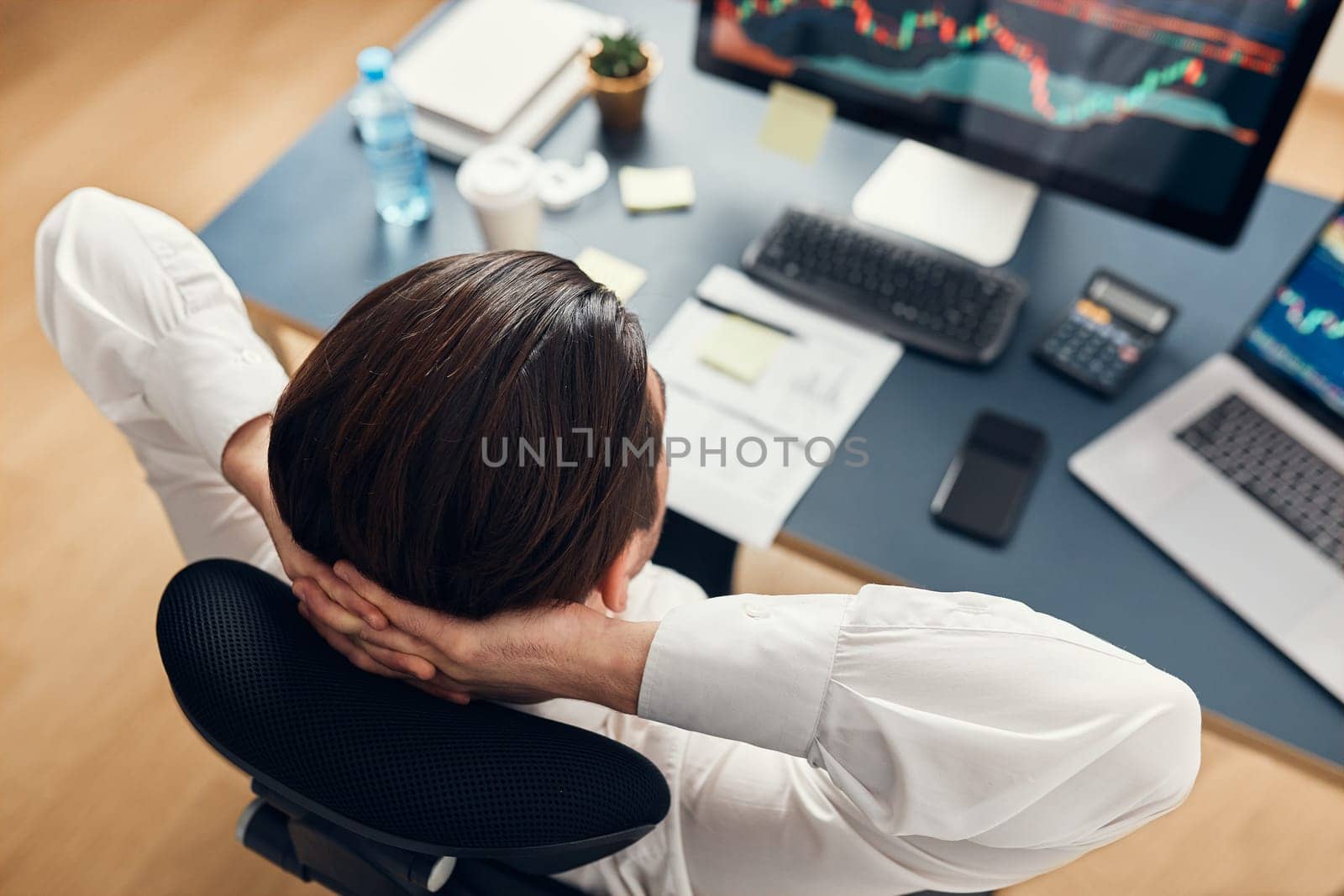 Businessman trading stocks online. Stock investor analysing numbers at graphs and charts. Investor planning and analysing stock market profiit. Man working with stock chart data. Business man investing stock using online platform. Business success concept