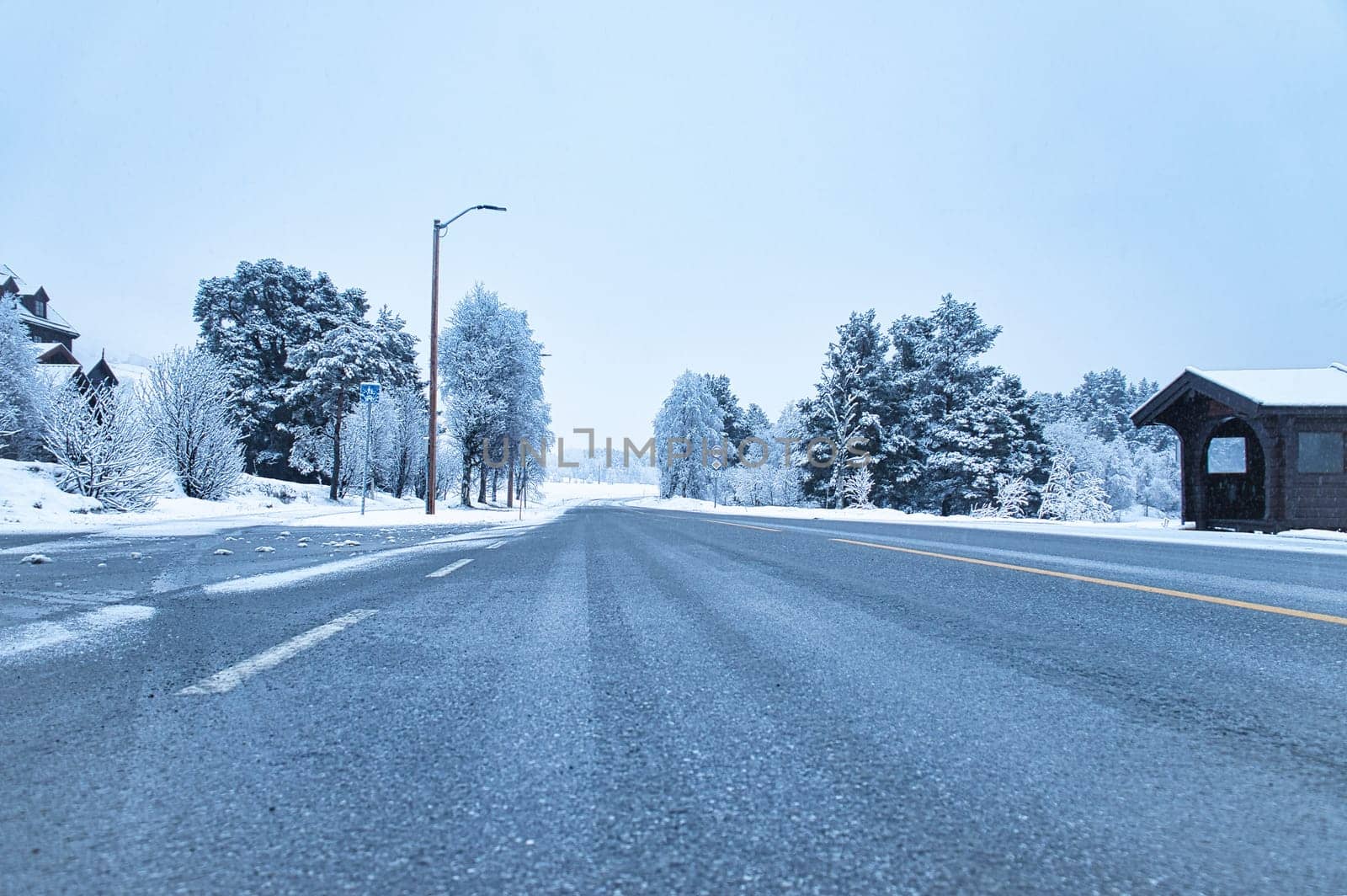 Winter landscape in Scandinavia. With snow covered trees on a road. Landscape photo from the north