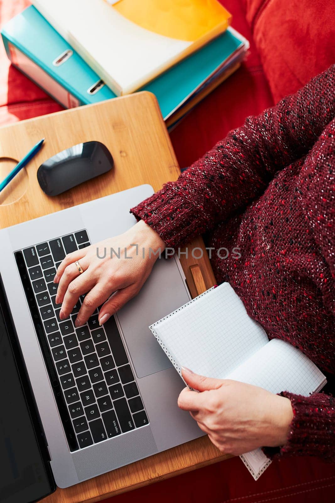 Woman mother working doing her job remotely during video chat call stream online course webinar on laptop from home during COVID-19 quarantine. Woman sitting on bed in front of computer looking at screen
