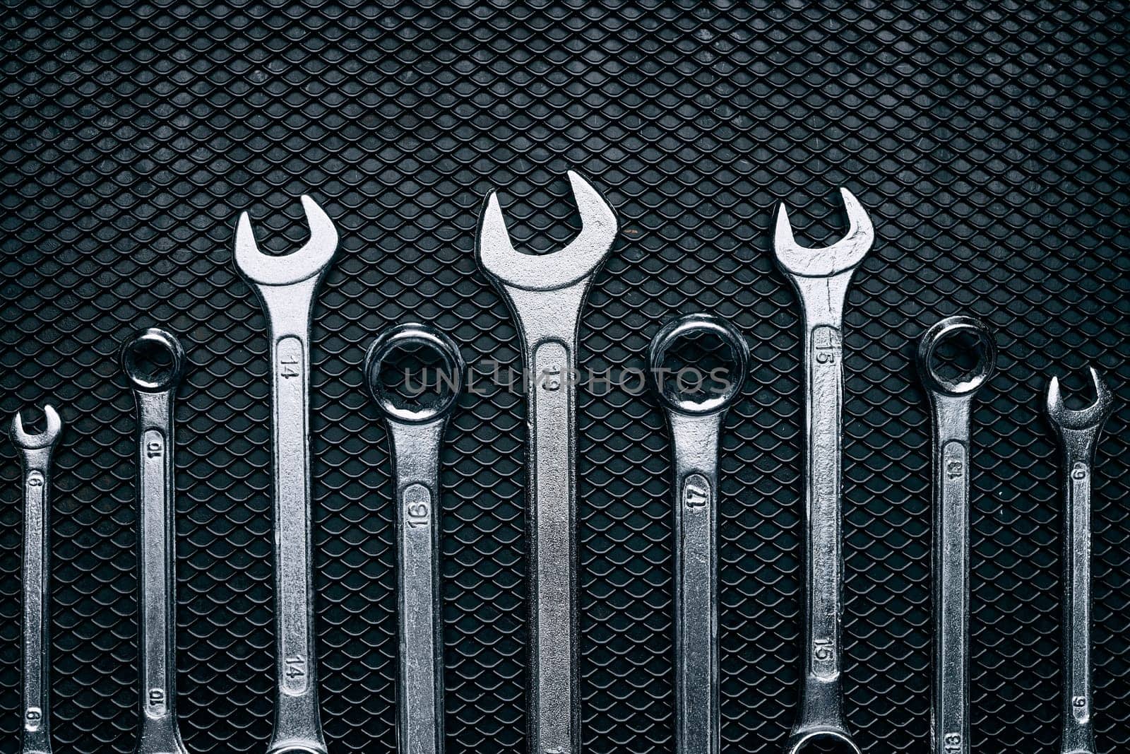 Set of chrome wrenches on steel surface. Mechanic tools for maintenance. Hardware tools to fix. Technical tools background