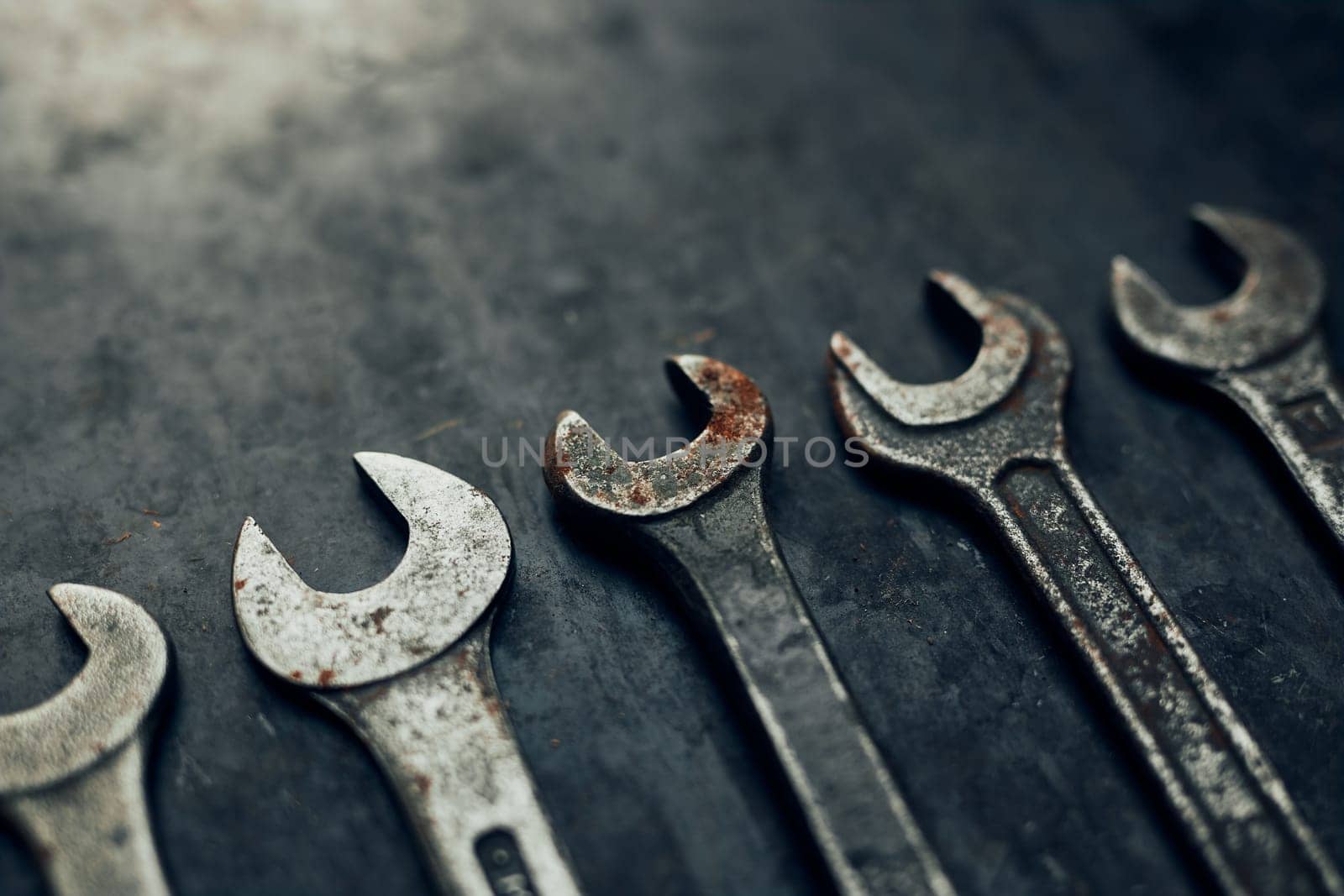 Spanners on steel surface. Old rusty wrenches for maintenance. Mechanic hardware tools to fix. Technical tools background with copy space