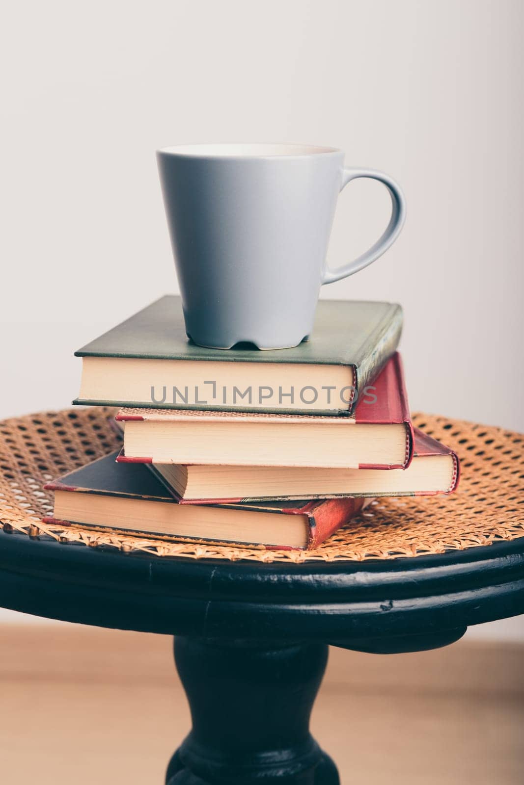 A few books with cup of coffee on chair