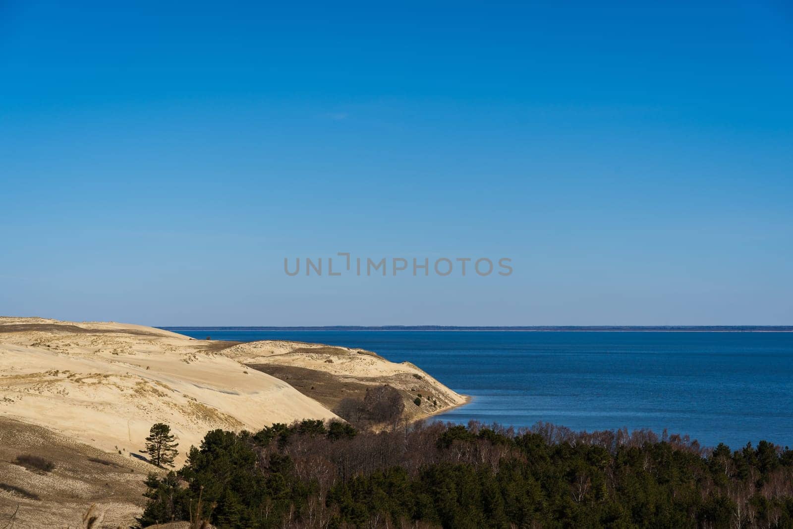 Baltic sea from Curonian Spit. The Gray Dunes, or the Dead Dunes is sandy hills with a bit of green specks at the Lithuanian side of the Curonian Spit.
