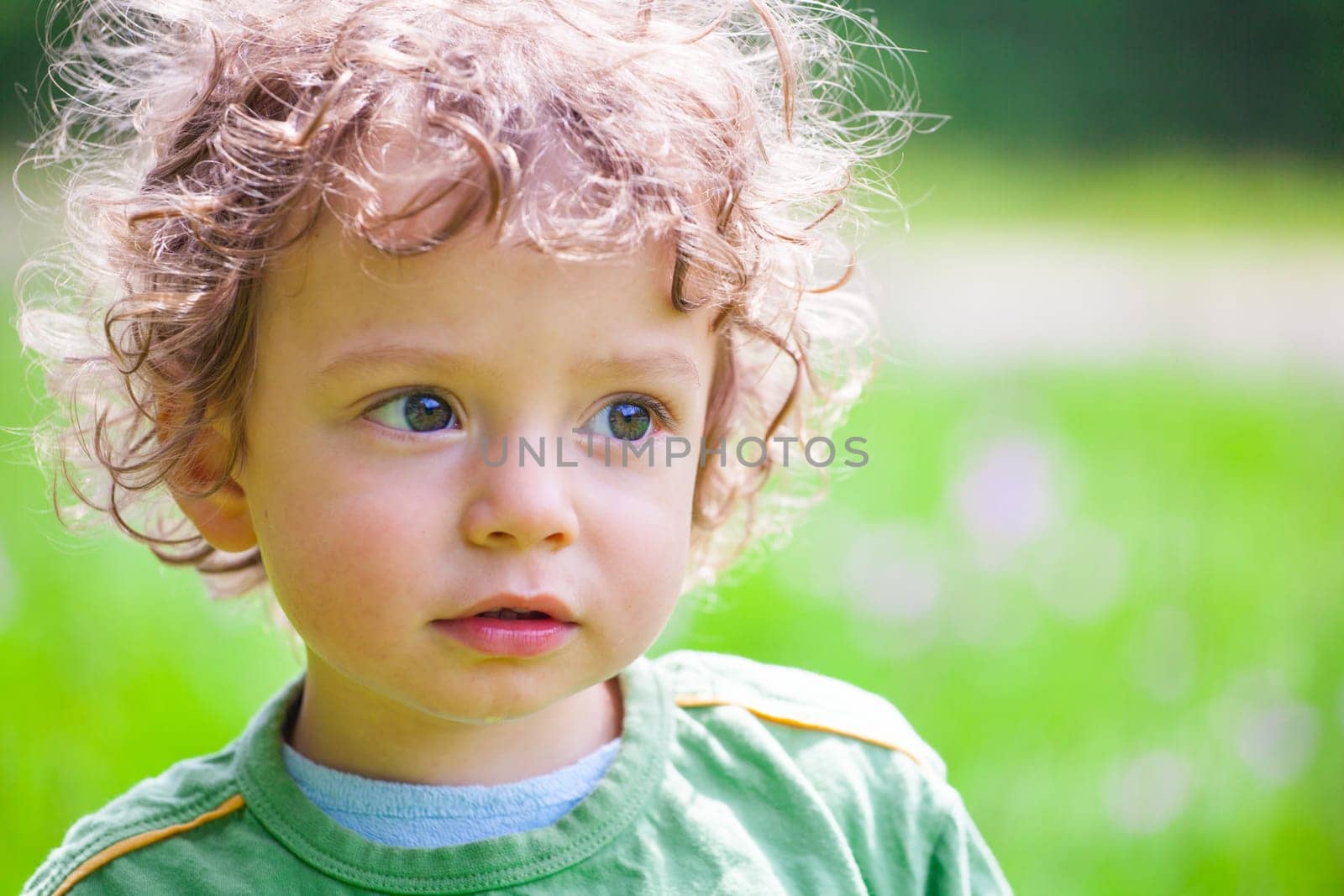 The portrait of a 1 and a half year old baby boy enjoying the outdoors.