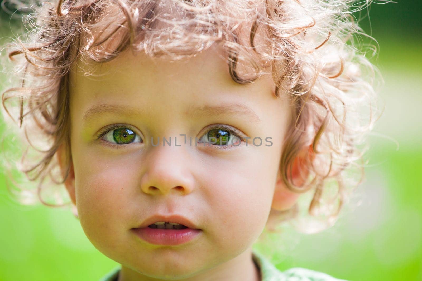The portrait of a 1 and a half year old baby boy enjoying the outdoors.