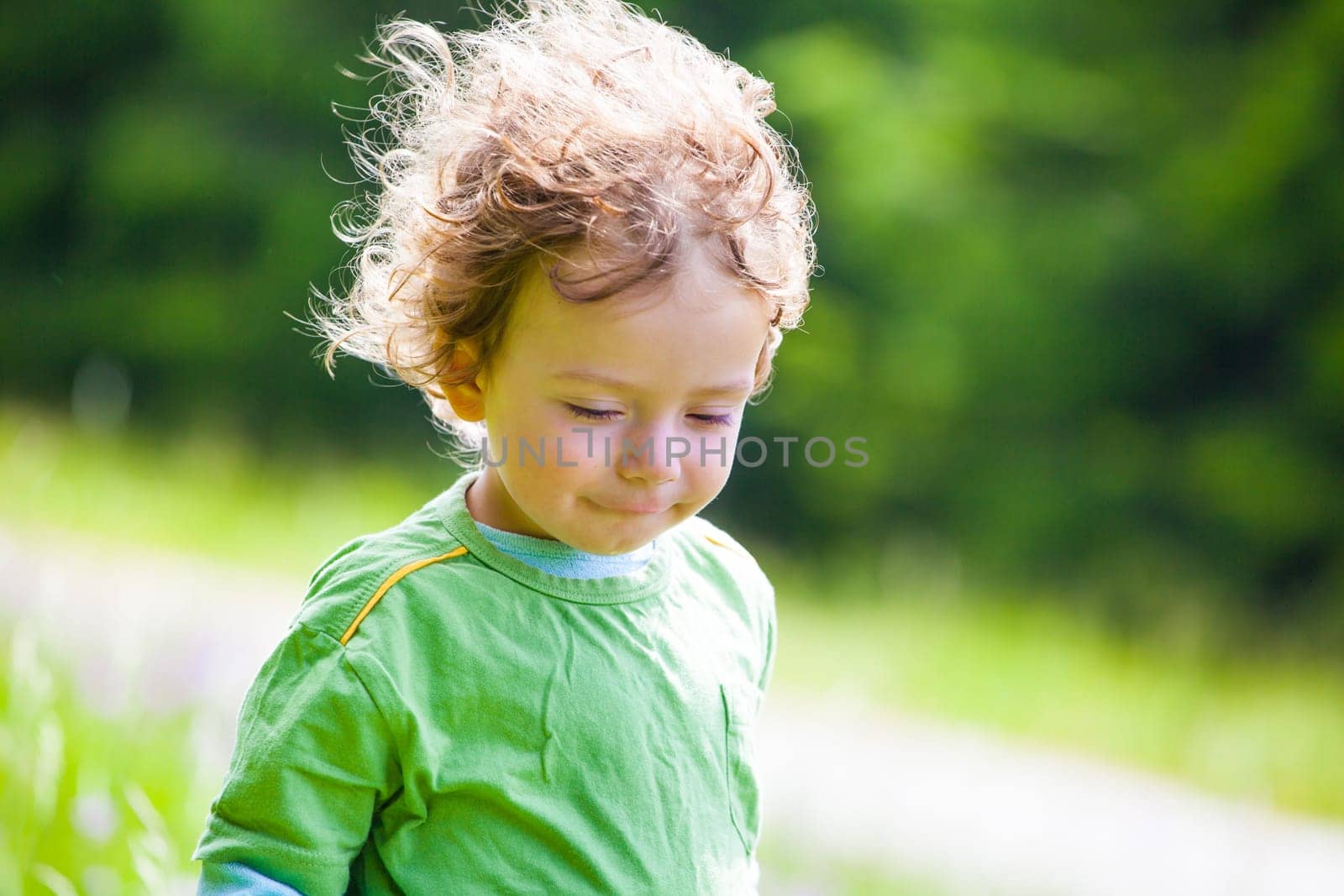 The portrait of a 1 and a half year old baby boy enjoying the outdoors.