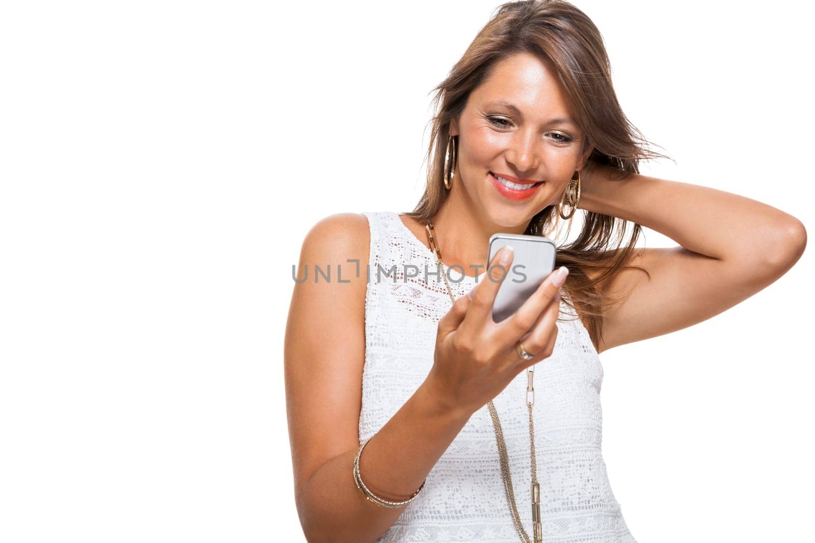 Young attractive woman reacts to a text message on her phone smartphone with open dark hair with text clearance isolated freeholder
