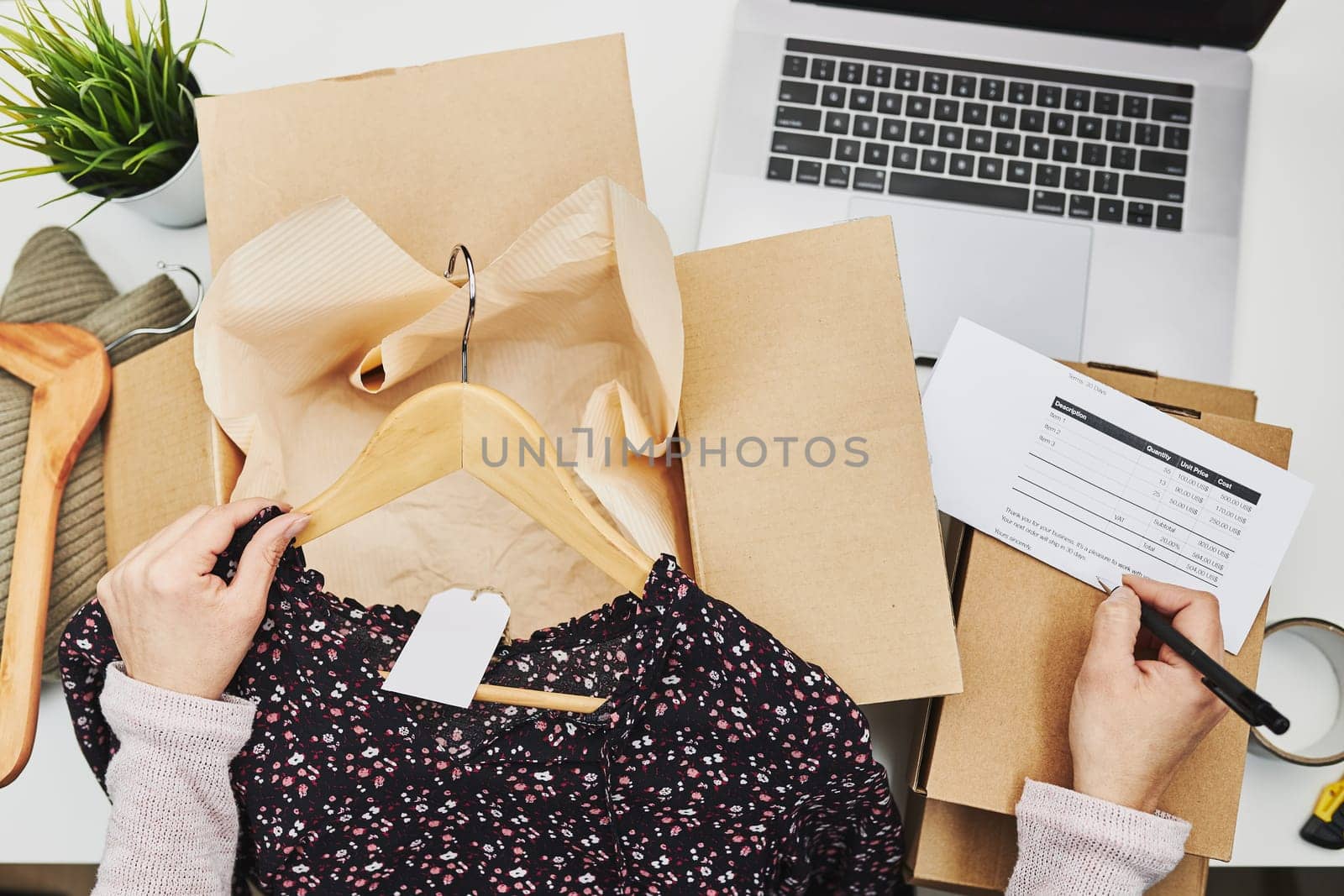 Business owner packing online order to delivery to customer. Preparing parcel box with clothes product from online shop