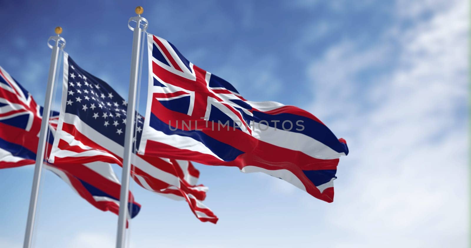 Hawaii state flag waving with the national flag of the United States of America on a clear day. 3d illustration render. Fluttering fabric. Selective focus