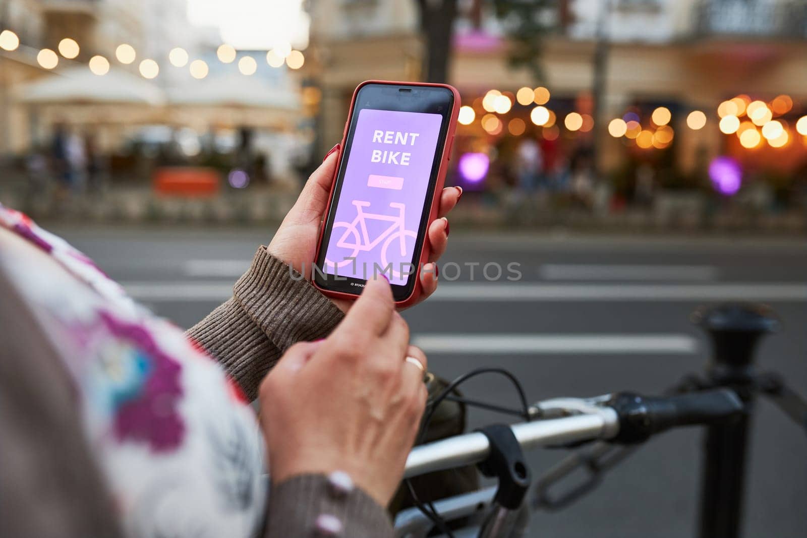 Renting bike using rental app on smartphone. Using bike sharing city service. Paid rent of electric scooter. Using mobile phone to rent and pay for public eco transport. Bike sharing city station. Ecological transport alternative. 24/7 rental mobile service