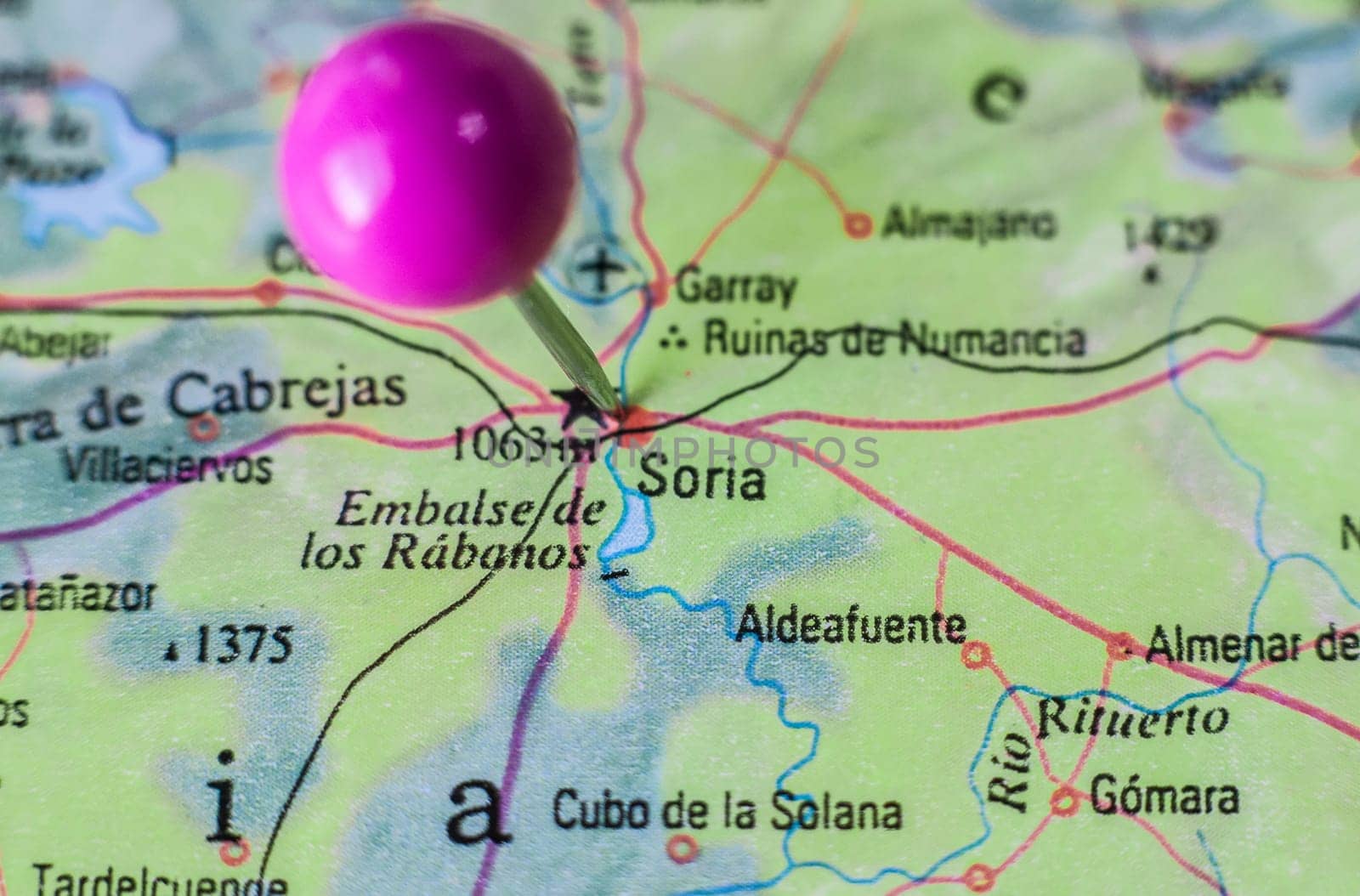 Pushpin marking on Soria, Spain. Selective focus on city