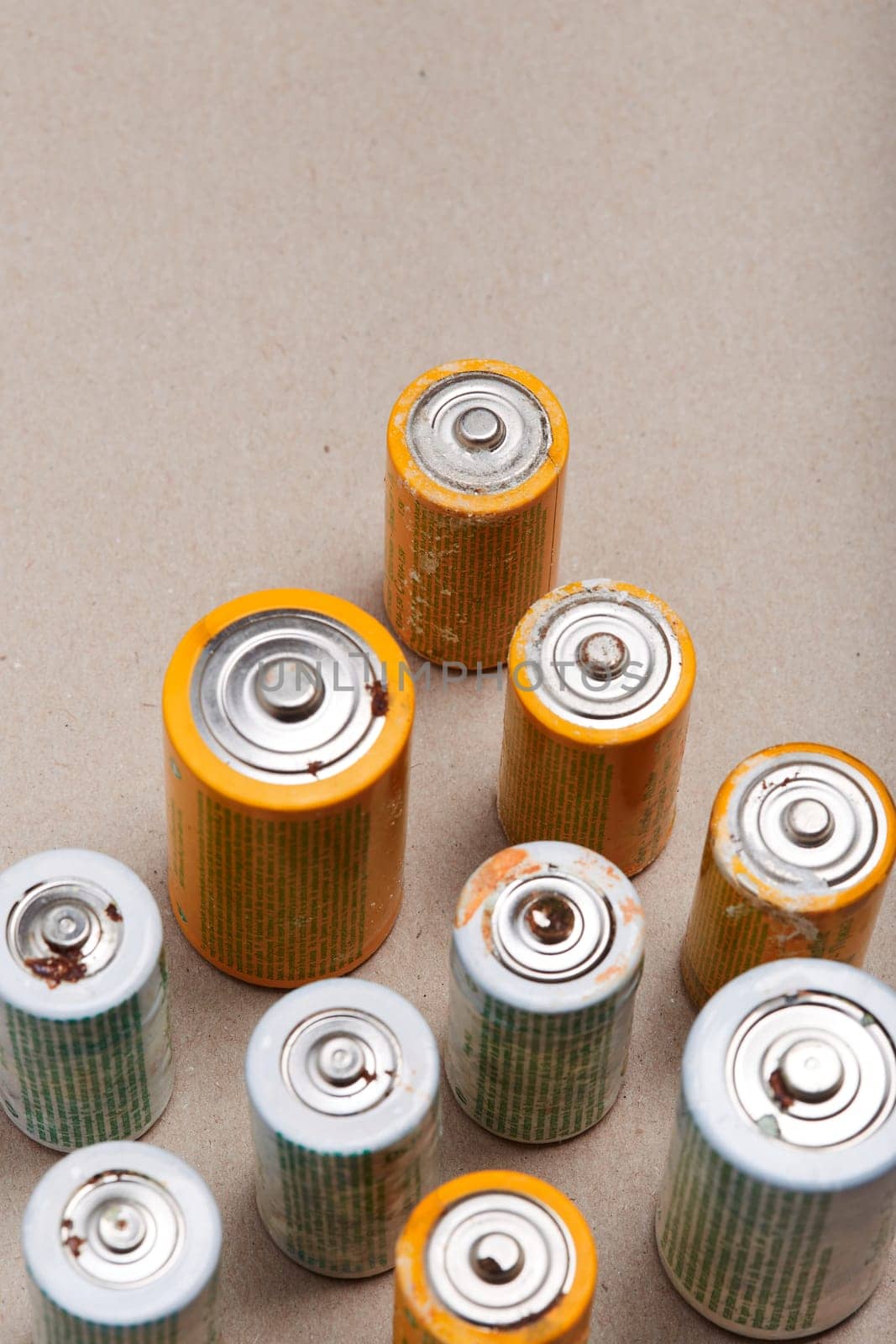 Discharged batteries on paper background. Collecting used batteries to recycle. Waste disposal and recycling. Copy space for text