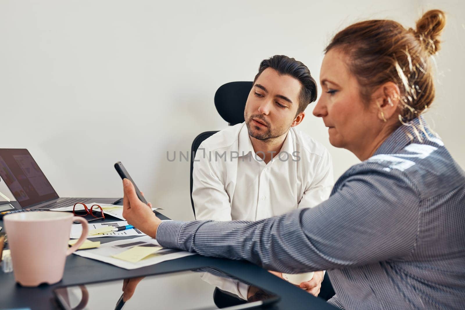 Business colleagues having video call discussing financial data working together in office. People entrepreneurs working with charts and tables on computer. Team working together. Workmates talking about project