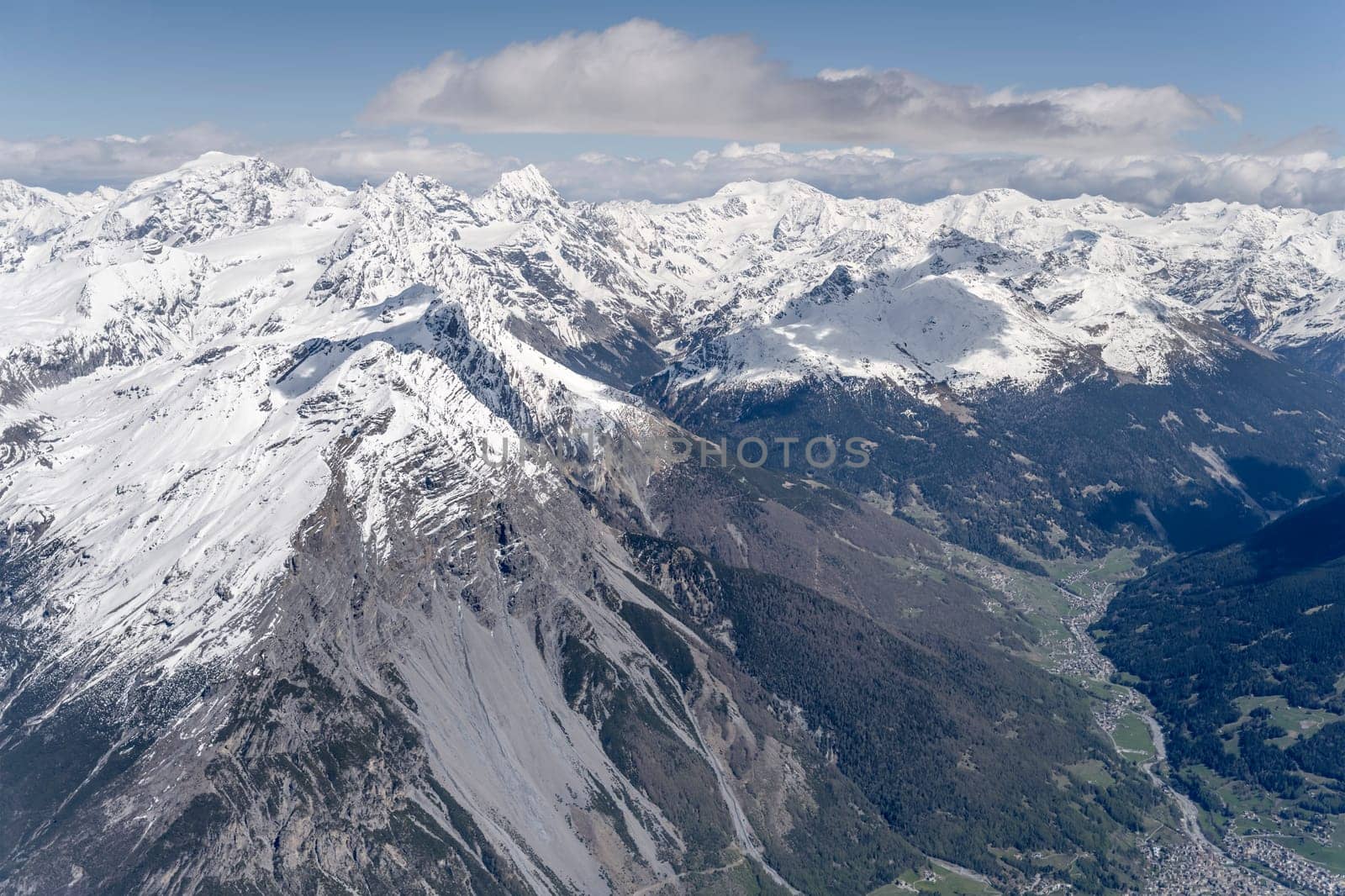 aerial landscape, from a glider plane, of Reit peak range, shot from west in bright late spring light, Sondrio, Italy