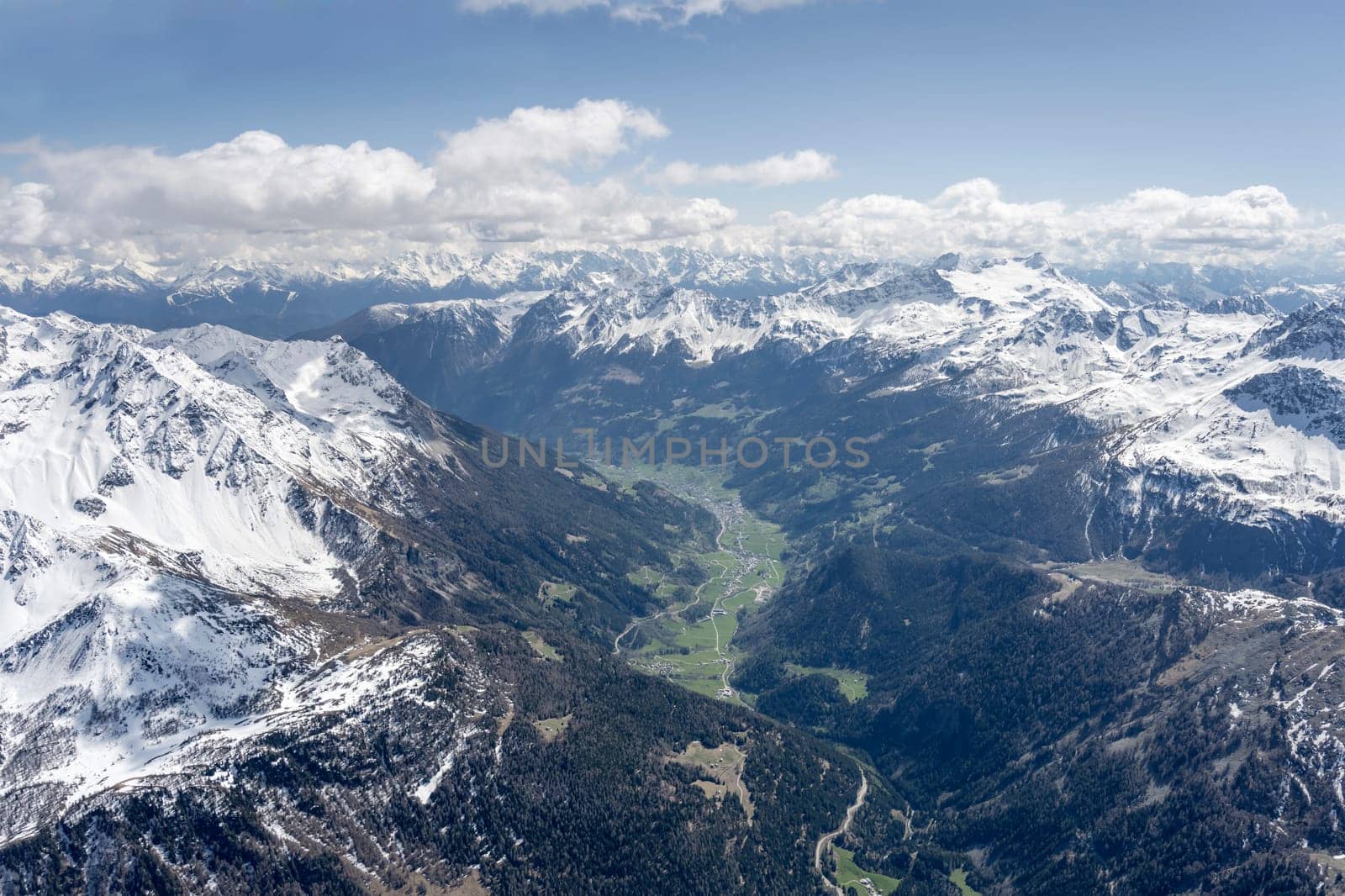 aerial landscape, from a glider plane, of Poschiavo valley, shot from north in bright late spring light, Poschiavo, Switzerland