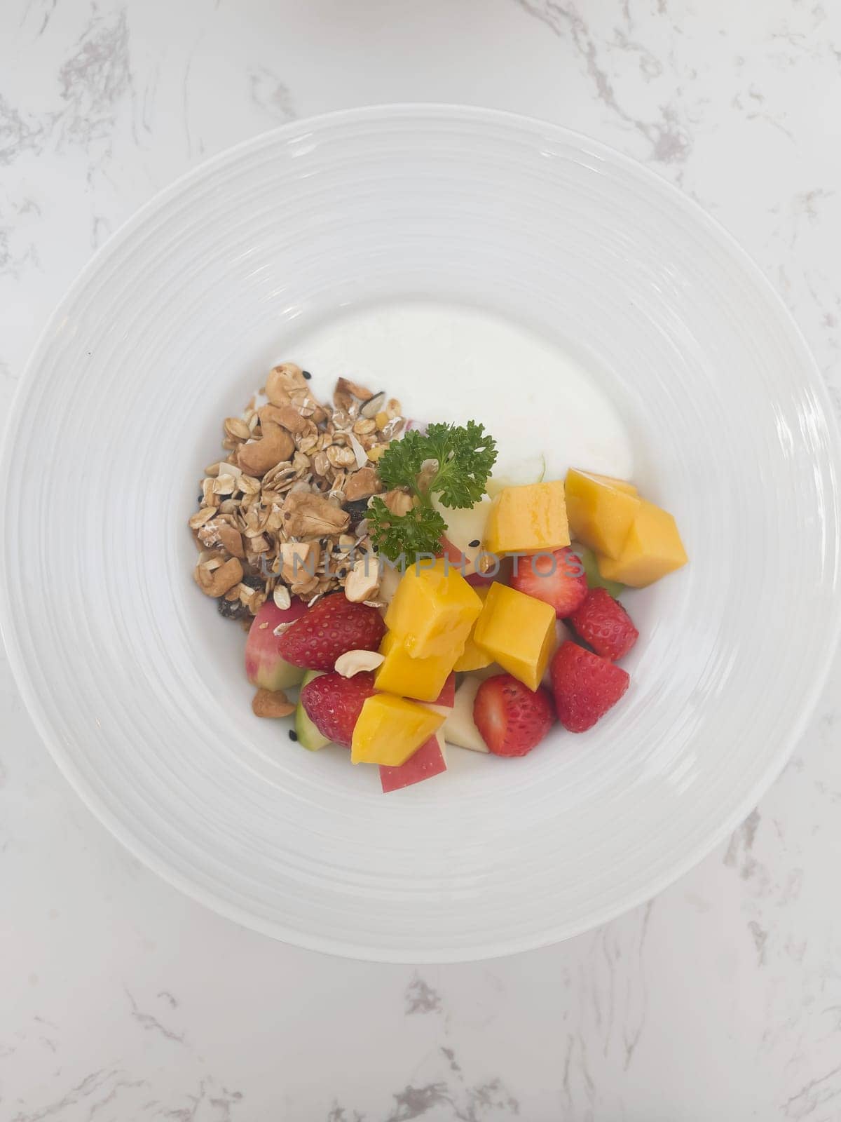 Greek yogurt with fresh fruit hole grain and honey in bowl, stock photo
