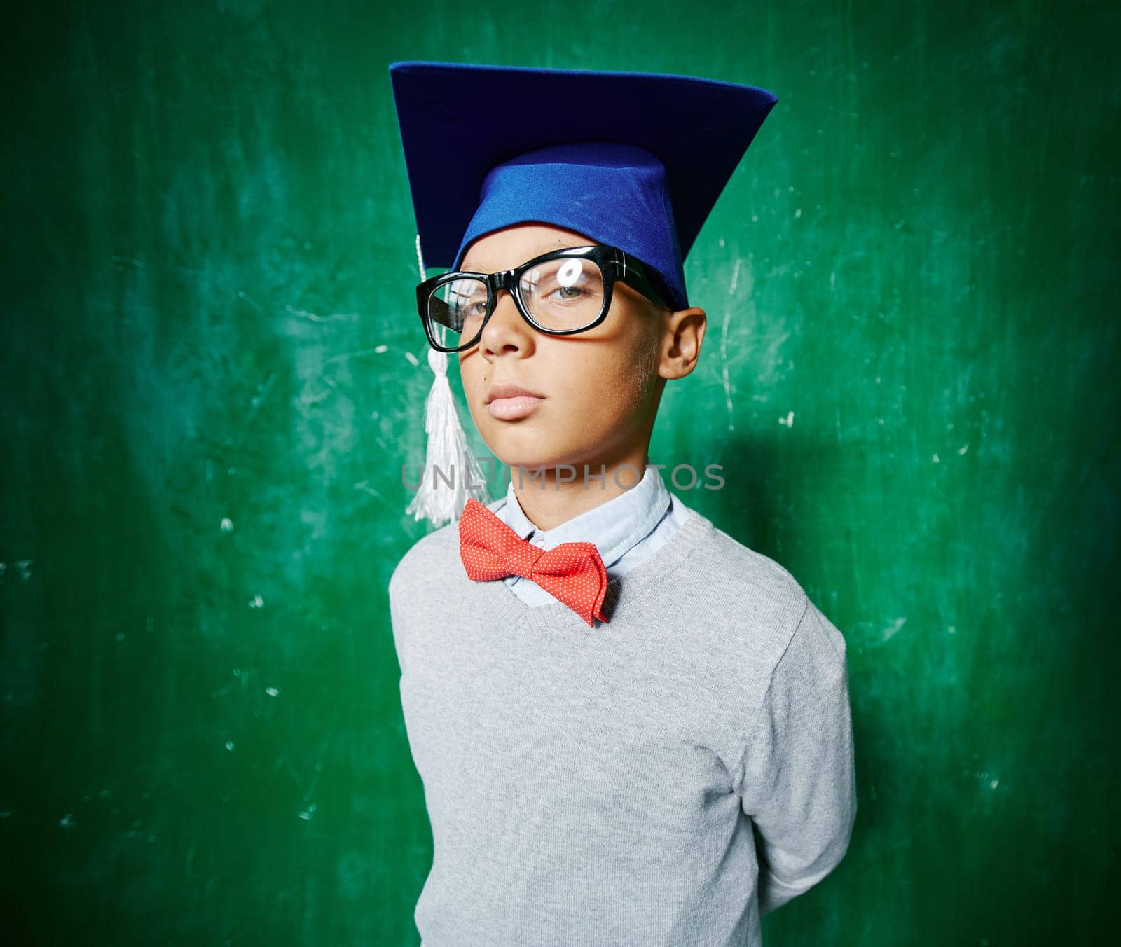 Serious graduate in eyeglasses looking at camera