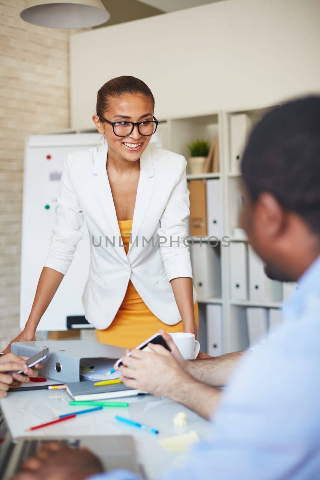 Smiling businesswoman listening to colleague at meeting