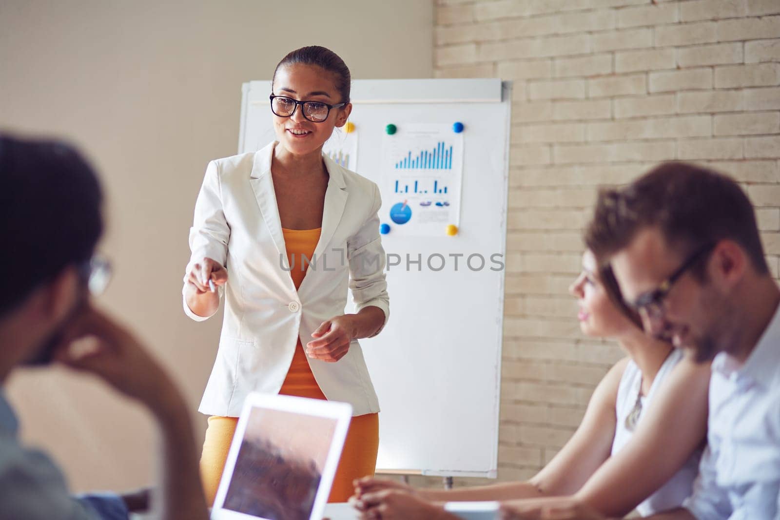 Group of employees listening to confident teacher explaining subject at seminar