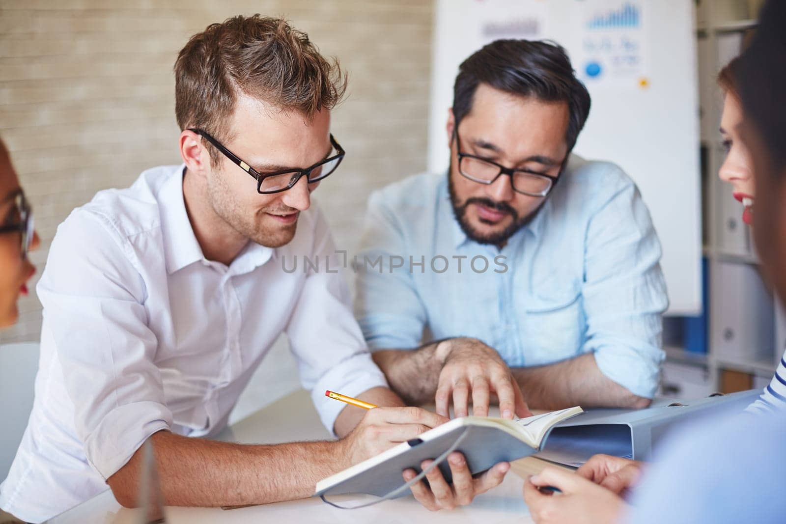 Group of managers discussing working plans at meeting
