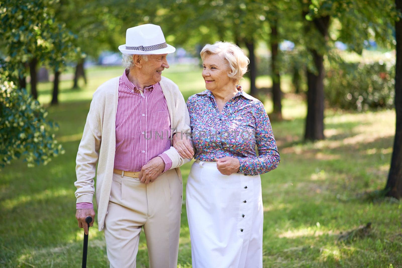 Senior couple in smart casual taking a walk and interacting