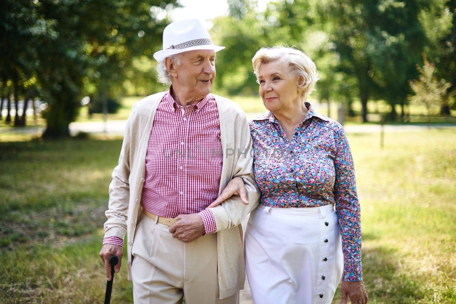 Senior couple in smart casual taking a walk