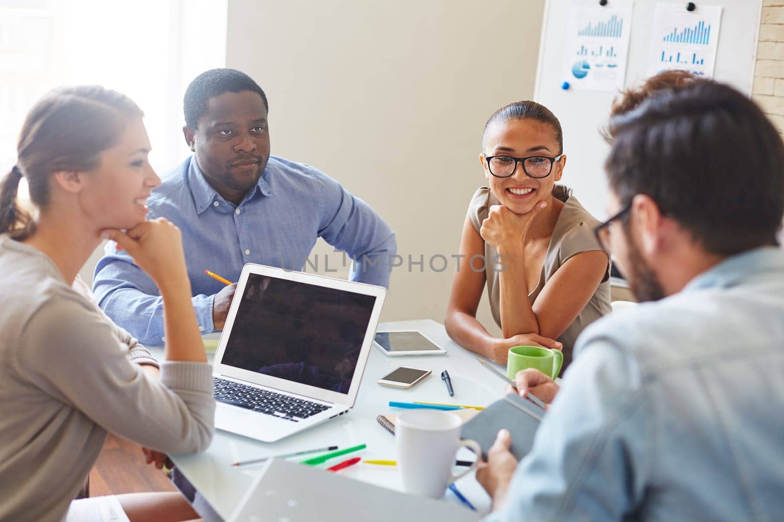 Group of confident business partners discussing plans and data