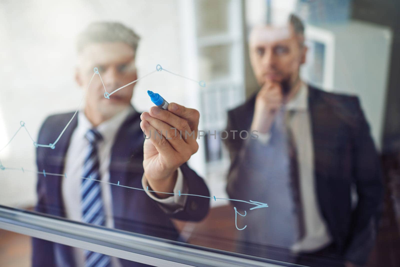 Businessman explaining graph to his colleague