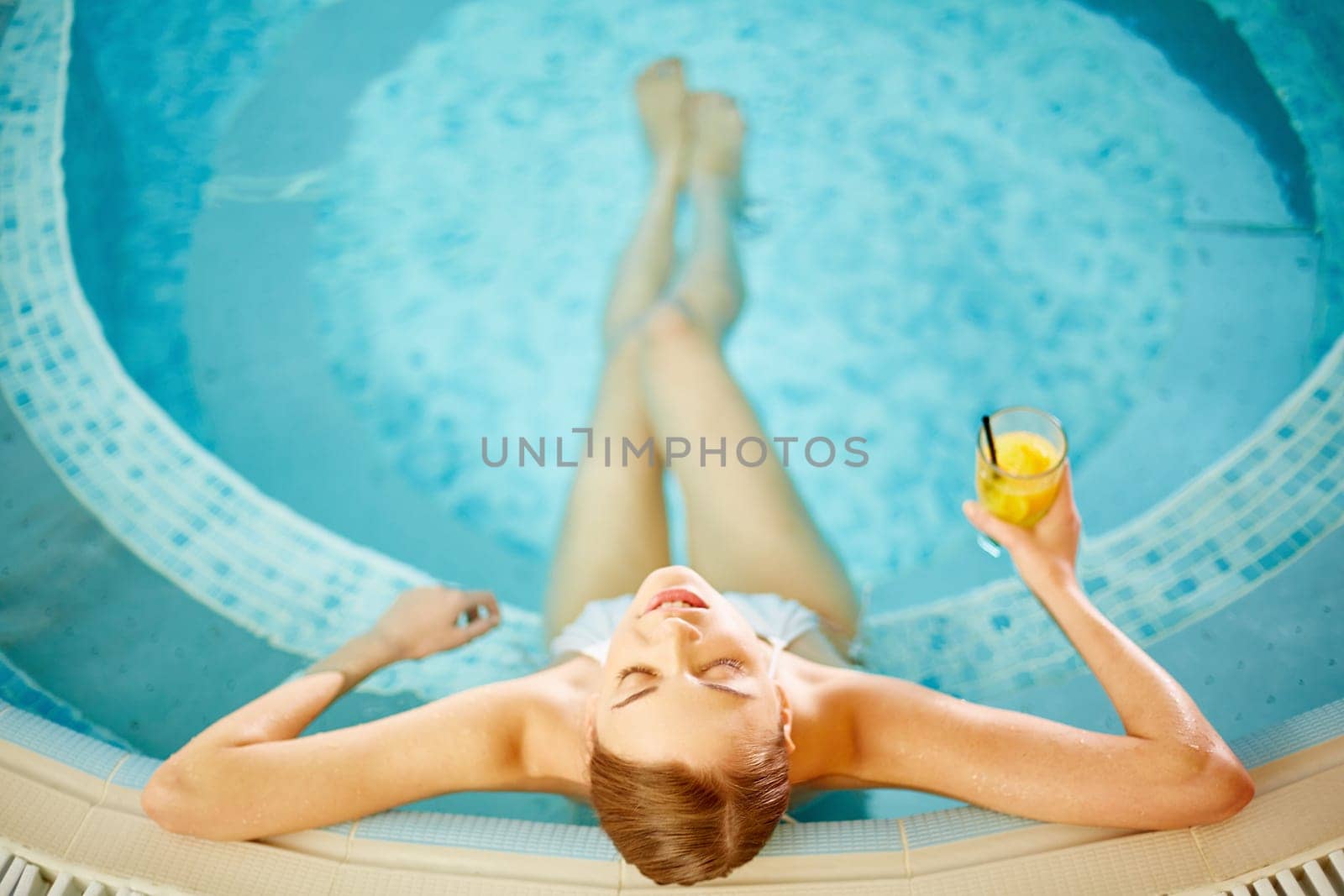 Beautiful girl in bikini relaxing in swimming pool