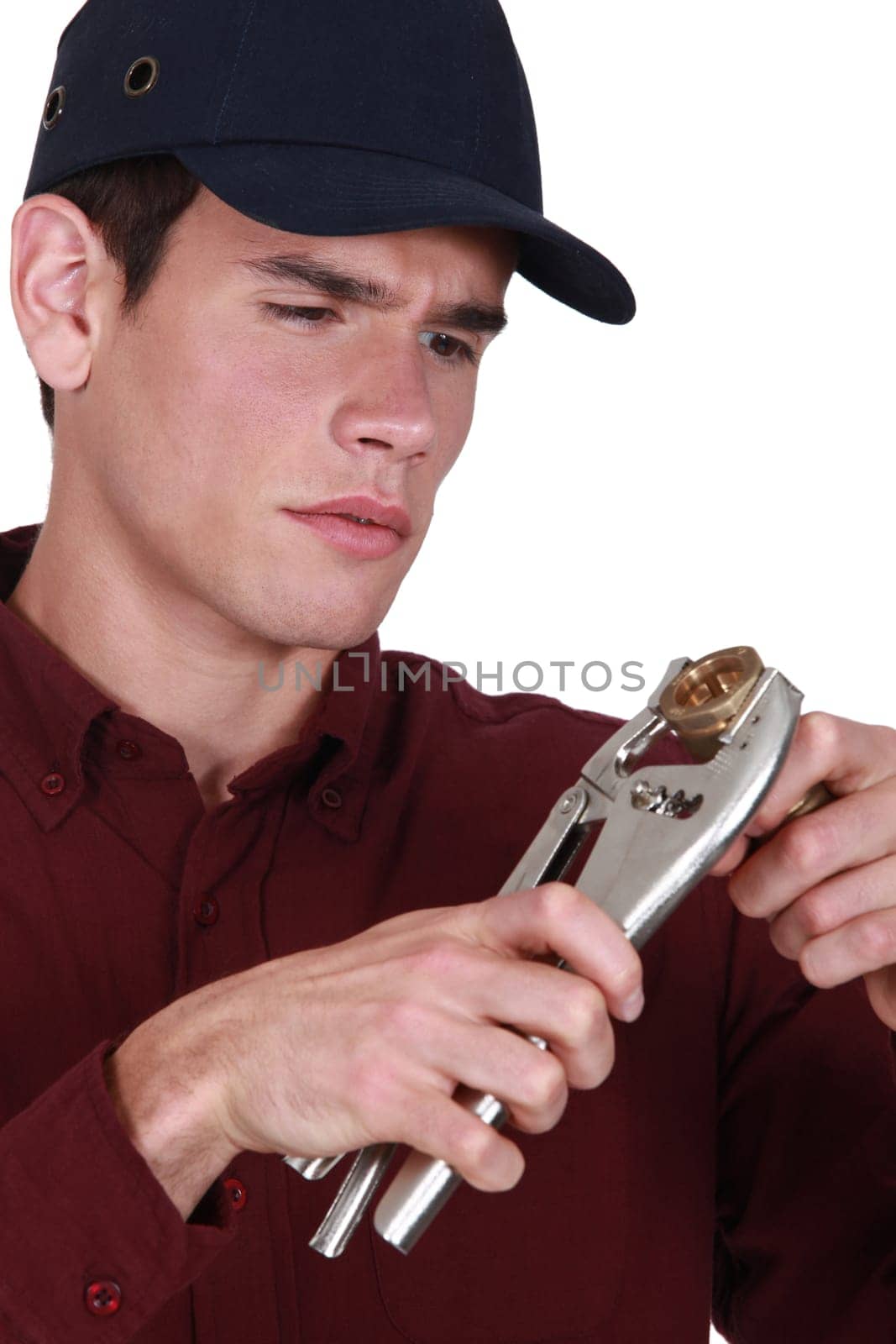 Plumber holding wrench and pipe