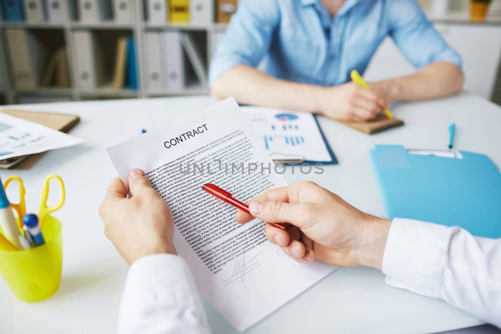 Businessman with pen pointing at contract