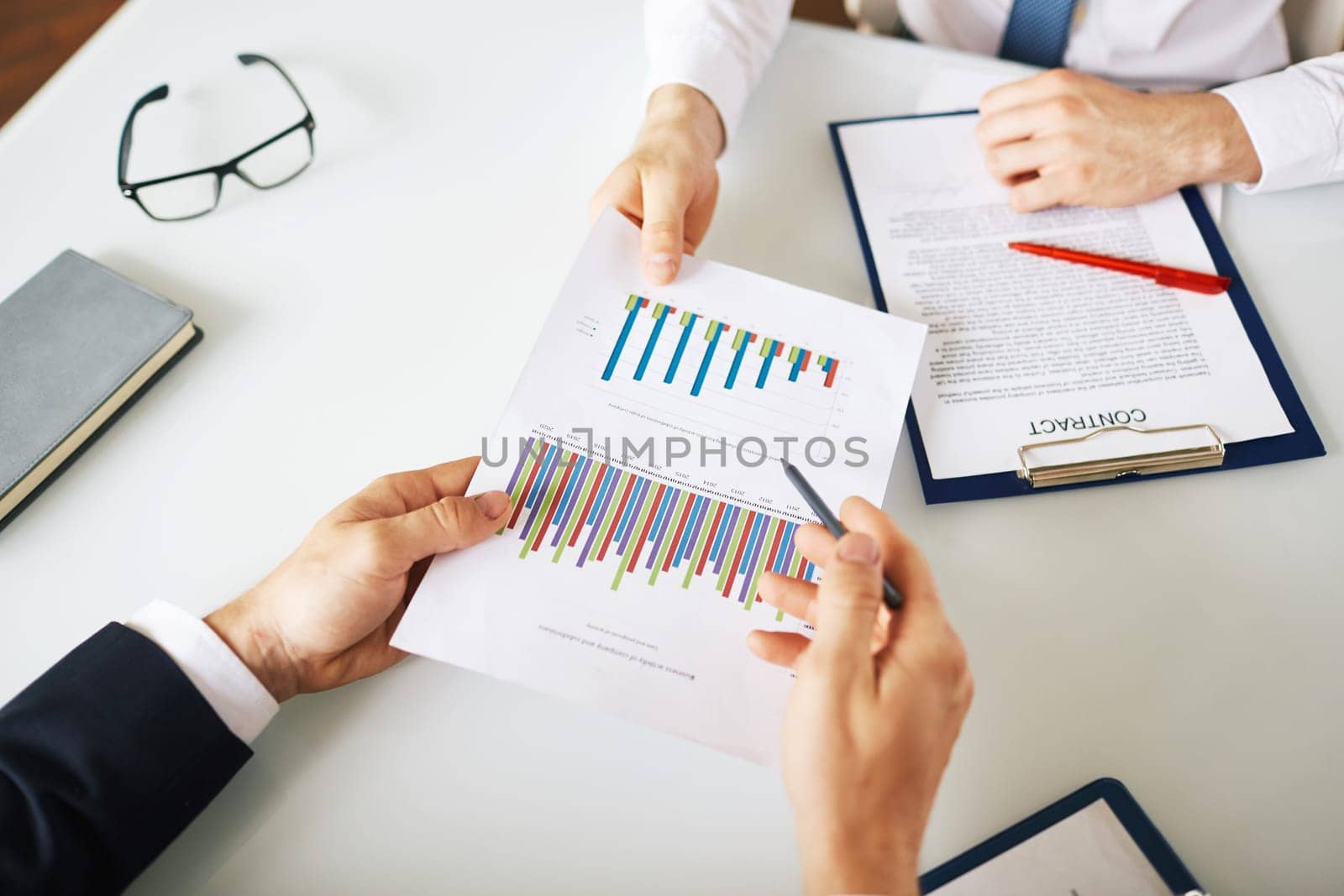 Businessman giving and explaining financial report to boss