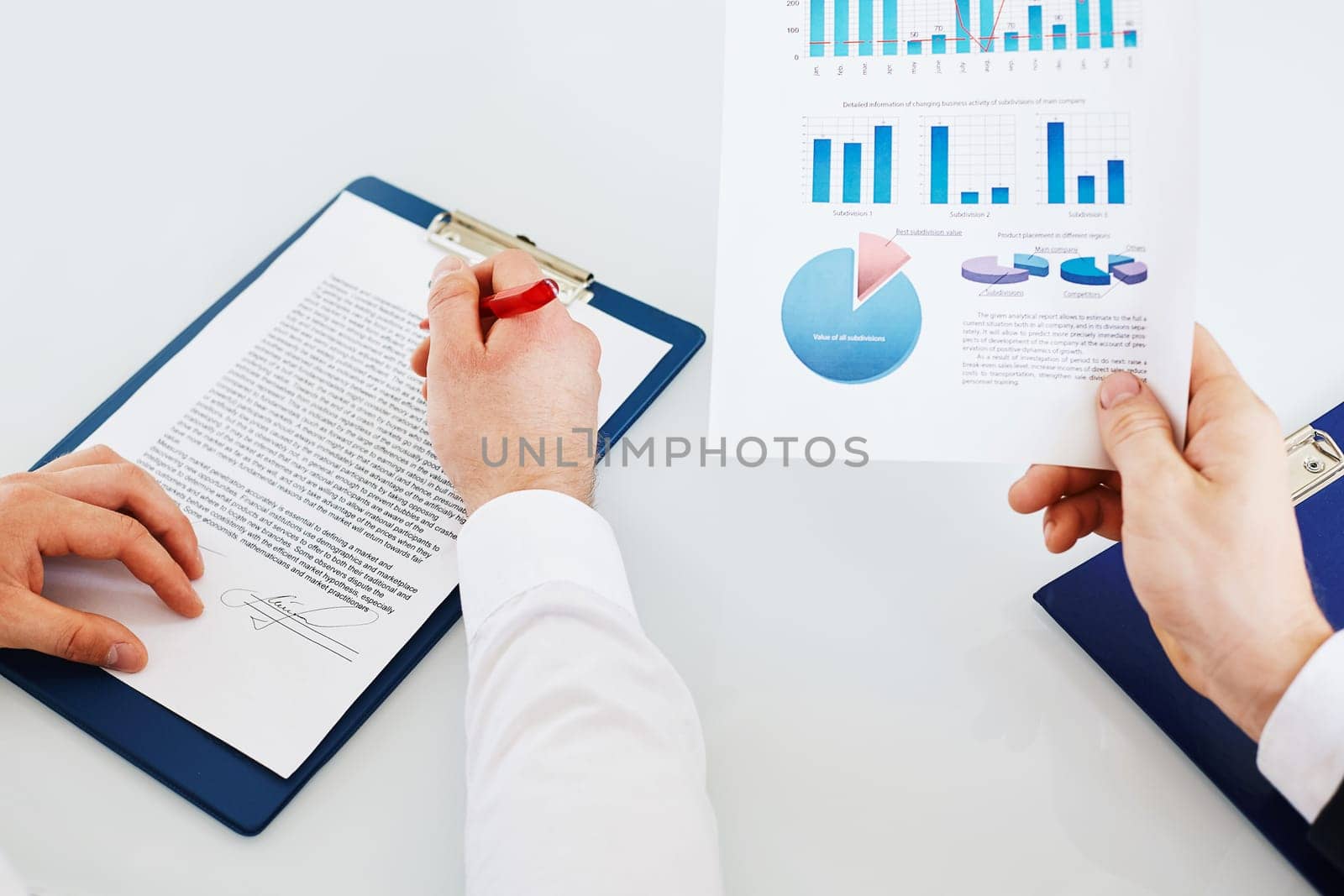 Hands of businessmen with papers during work