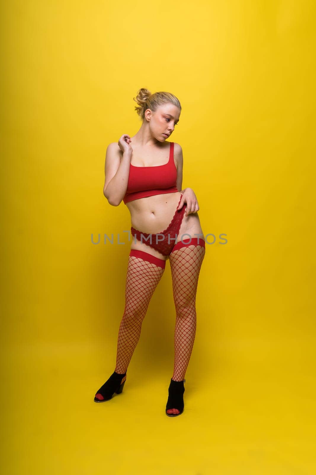 Fashion portrait of young beautiful woman with big breasts. Carefree model in lingerie.