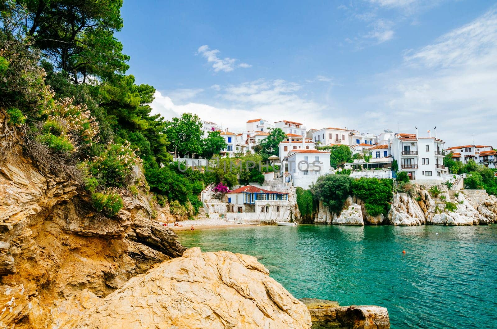 Old town view of Skiathos island, Sporades, Greece. Greek traditional architecture and aegean sea. Popular summer holiday destination scene.