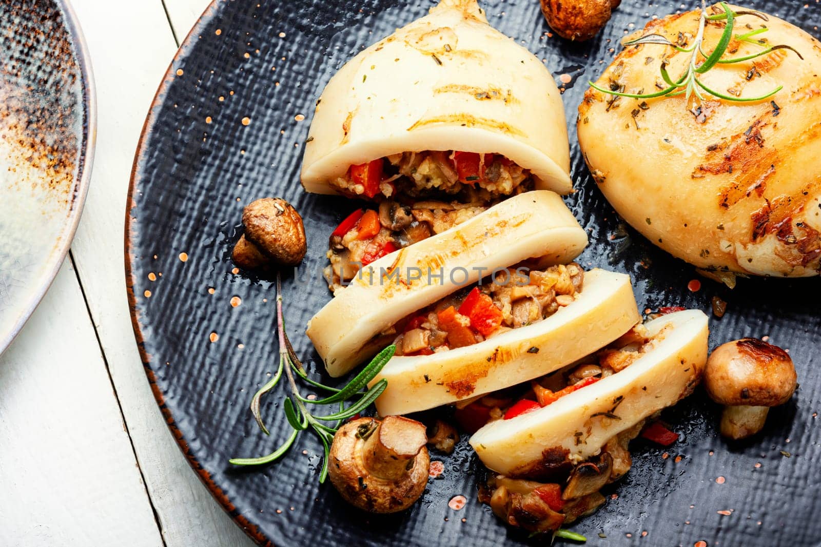 Baked stuffed squids with mushrooms. Stuffed calamari.