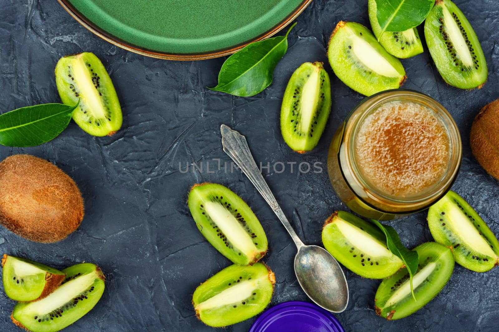 Fresh natural kiwi jam in a glass jar. Top view