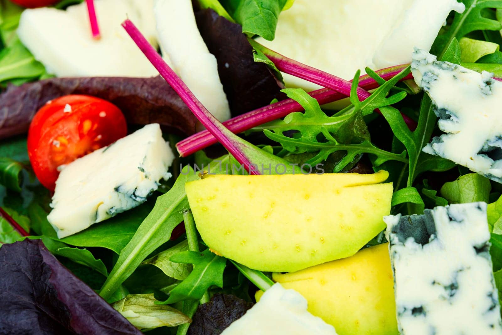 Salad with lettuce, greens, avocado, tomatoes and mix cheeses. Low calorie foods