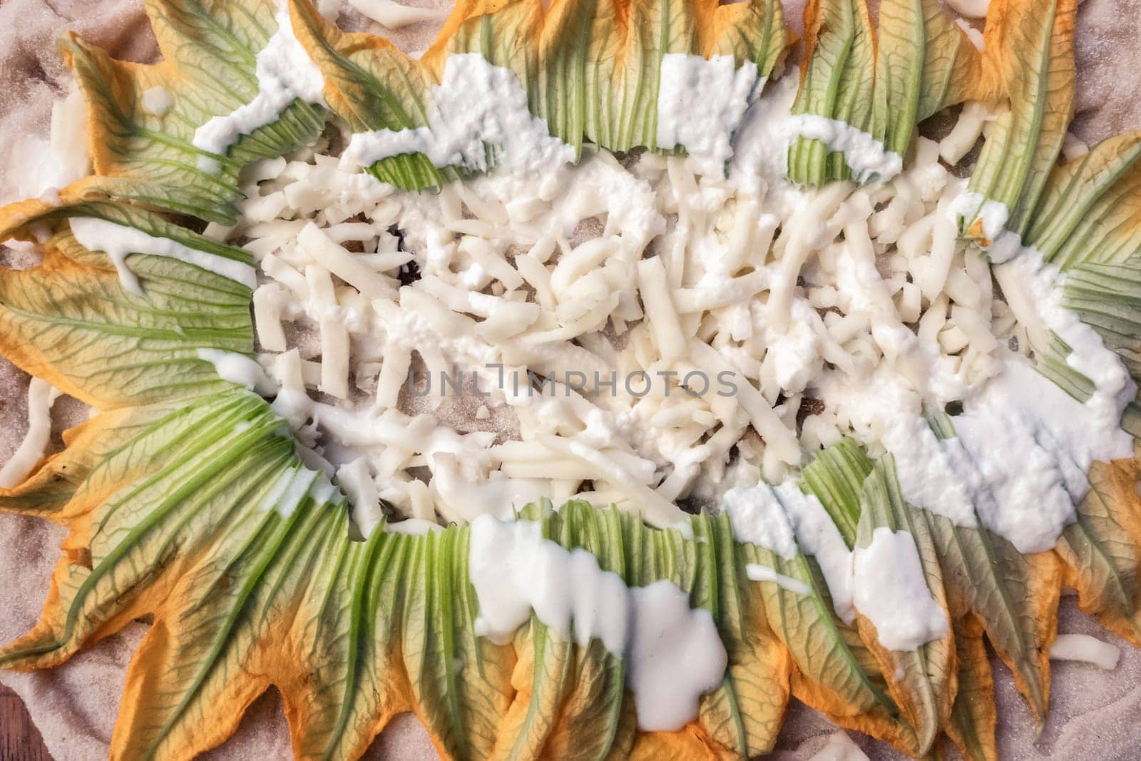 Closeup of raw pizza to bake, with mozzarella and zucchini. Vegetarian food.