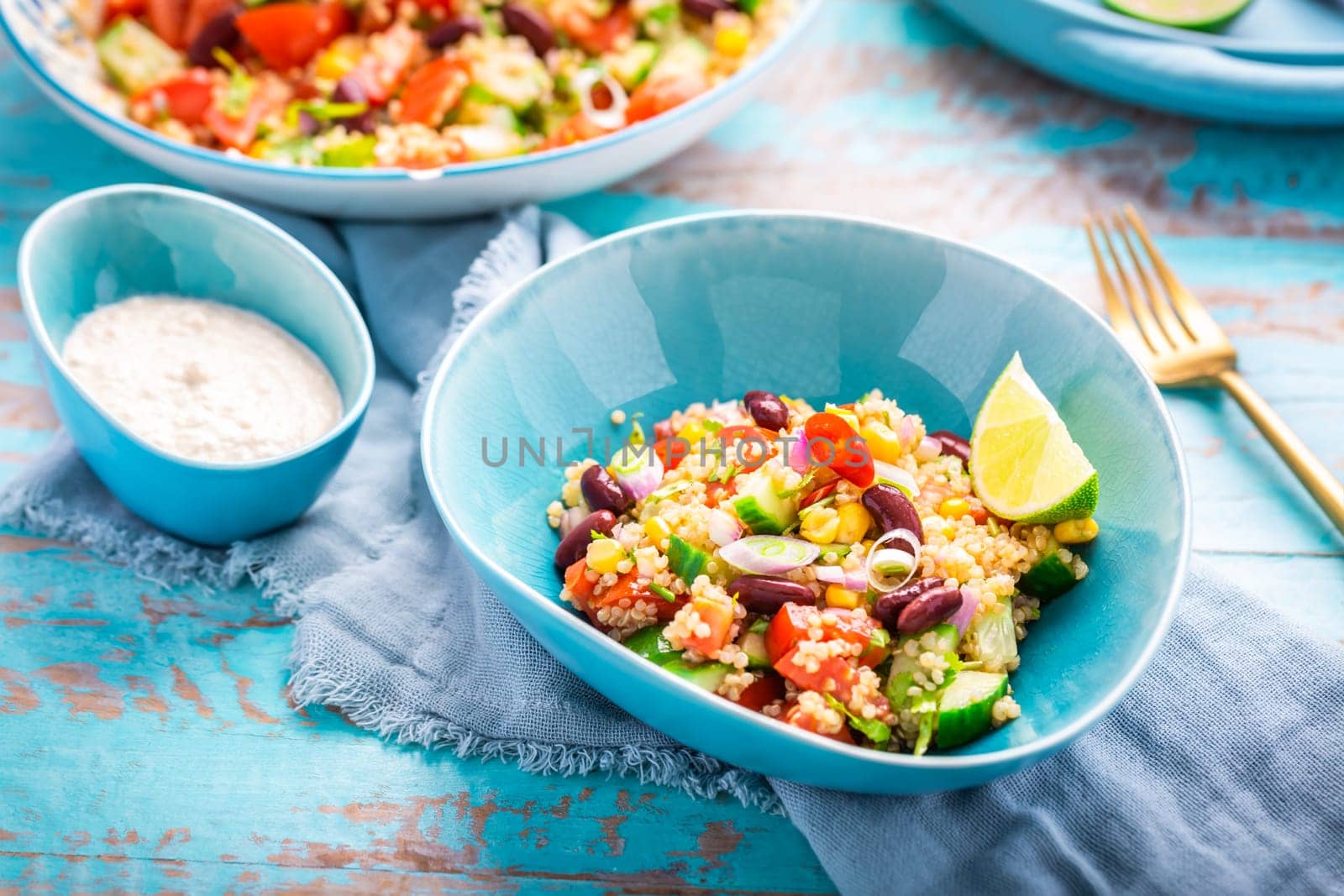 Mexican quinoa black bean salad with fresh tomatoes, cucumbers, onion and cilantro