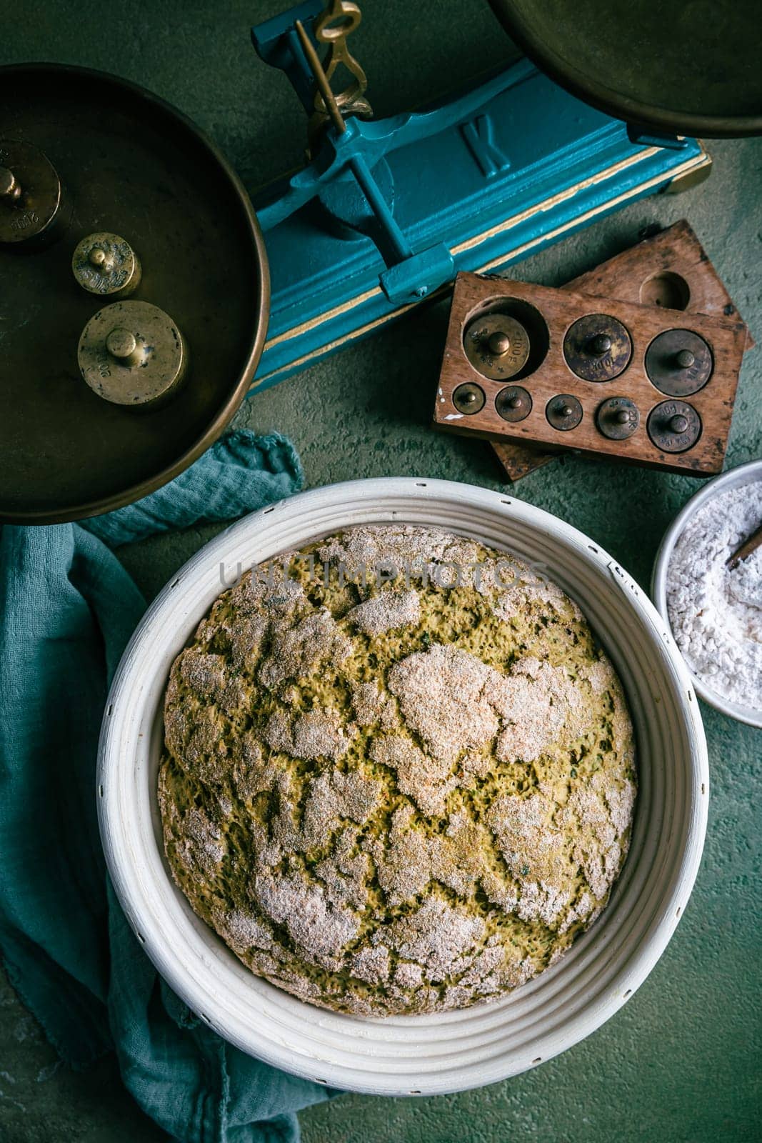 Homemade spelt bread with herbs and wild garlic, process of raising dough in a special basket. Dough made from natural sourdough, fermentation process