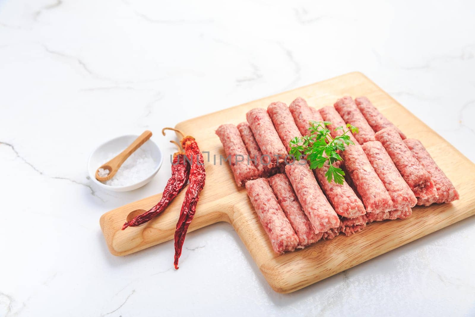 Raw serbian cevapi or cevapcici sausages. Traditional south european skinless sausages cevapcici made of ground meat and spices.