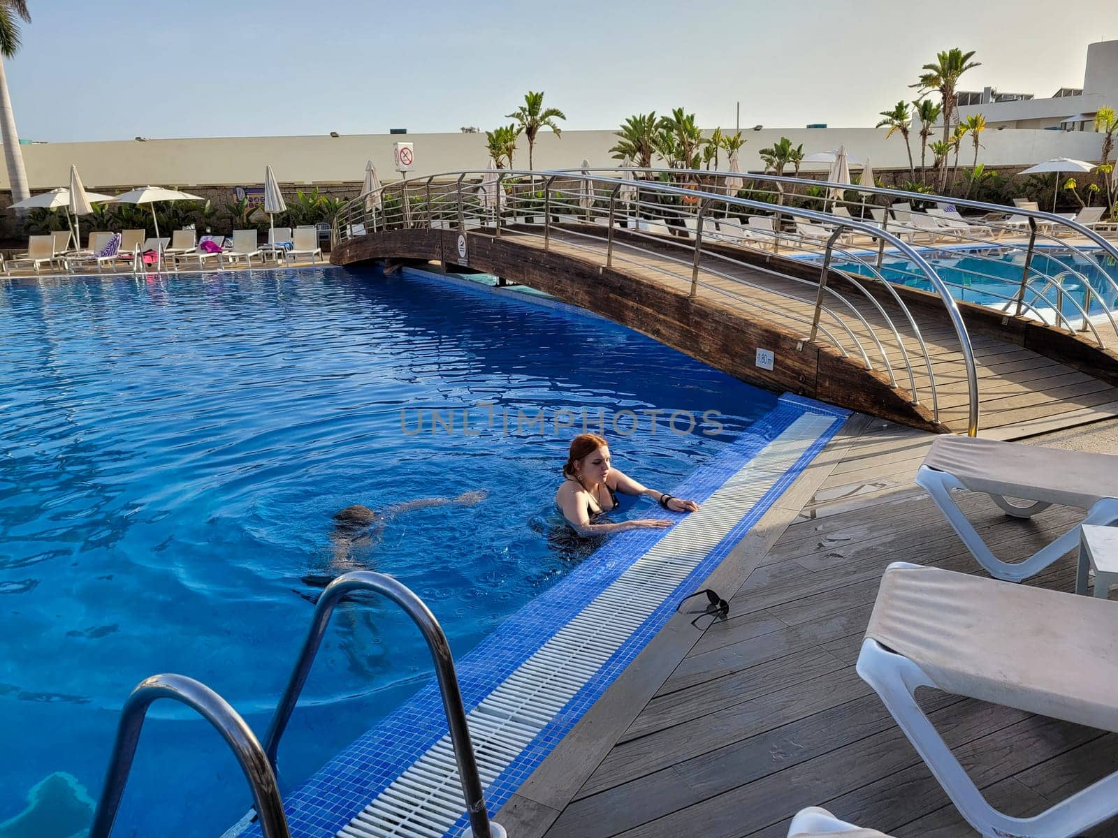 A boy and a teenage girl in a swimming pool