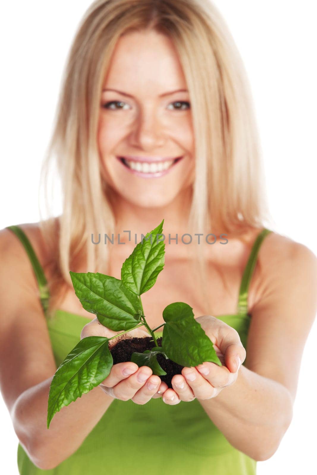 plant in blonde hands close up