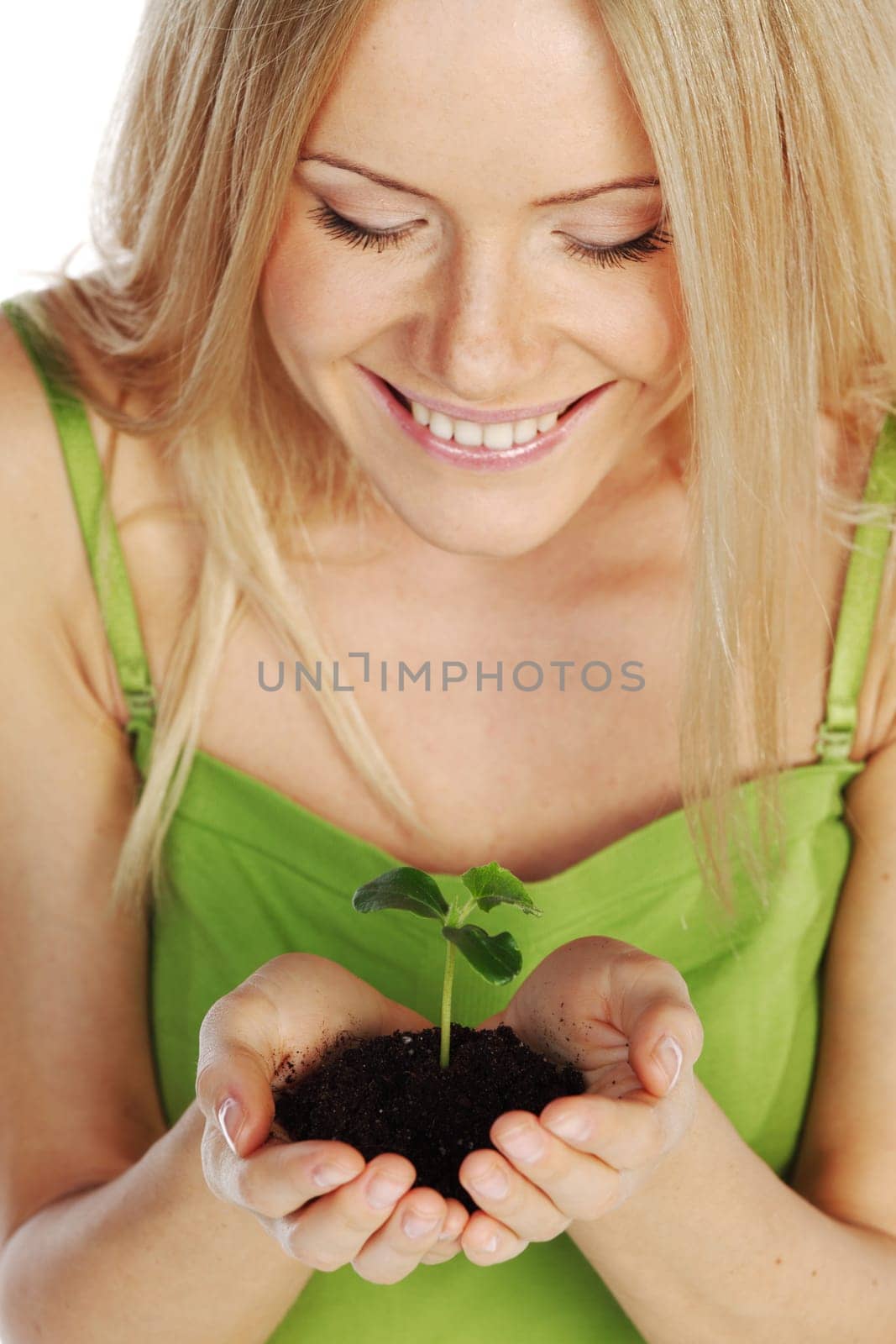 plant in blonde hands close up