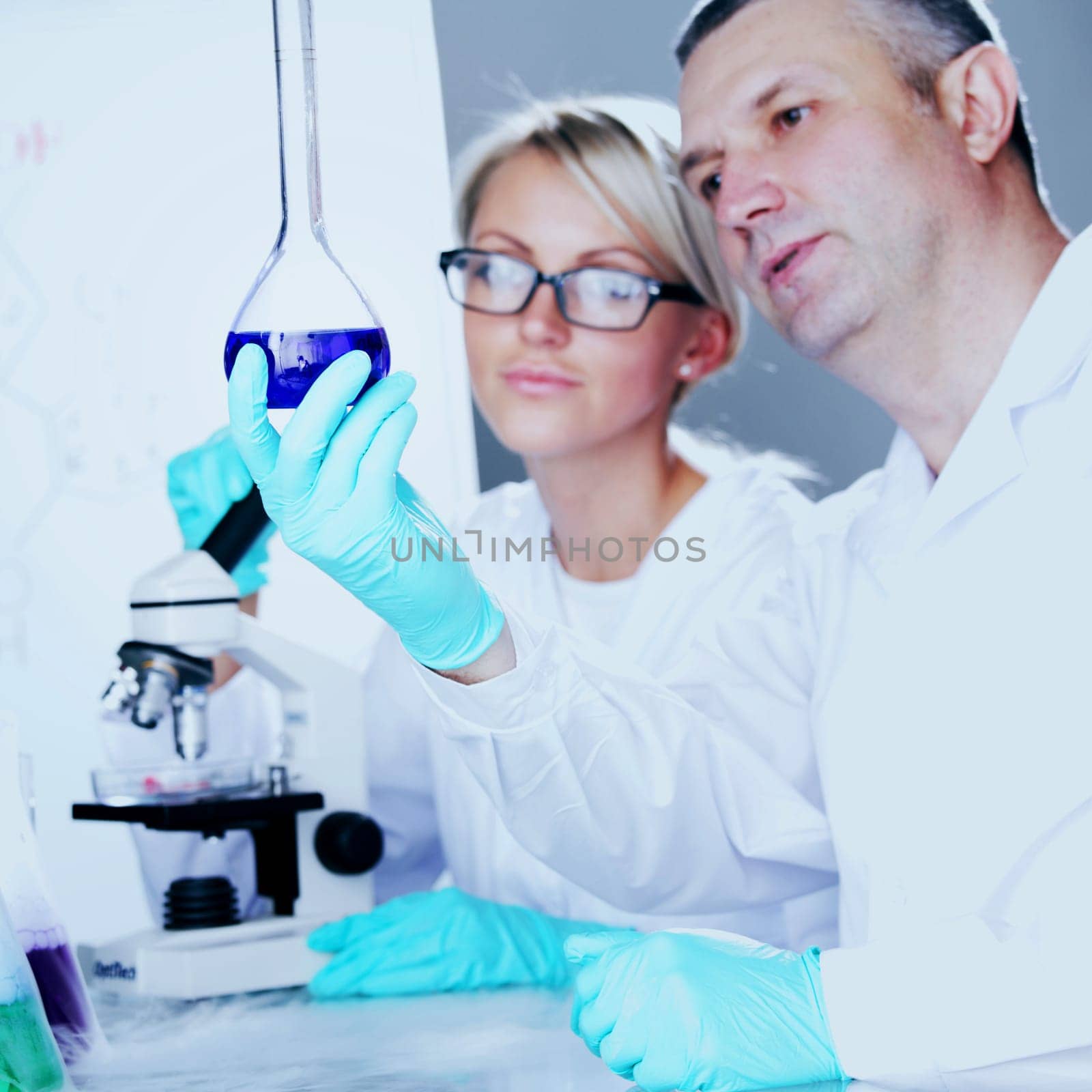 two scientist in chemical lab conducting experiments