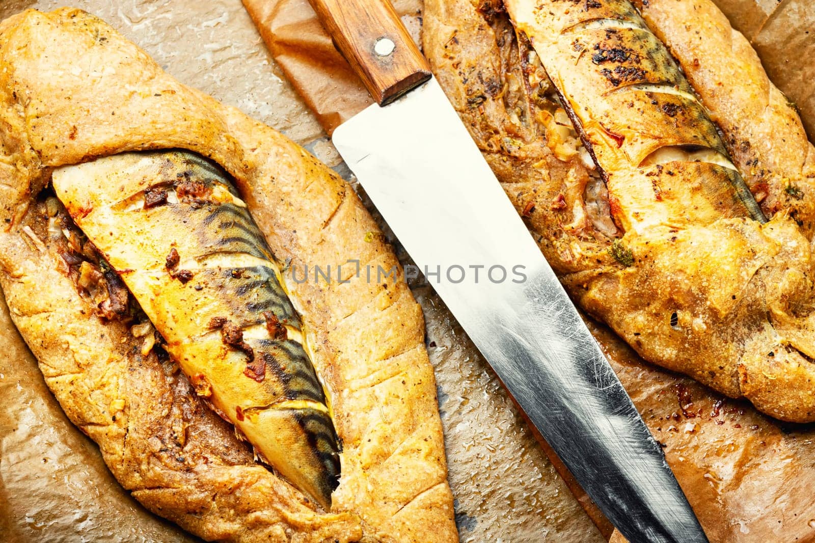 Delicious fish pie with mackerel on on baking paper. Fish baked in bread.